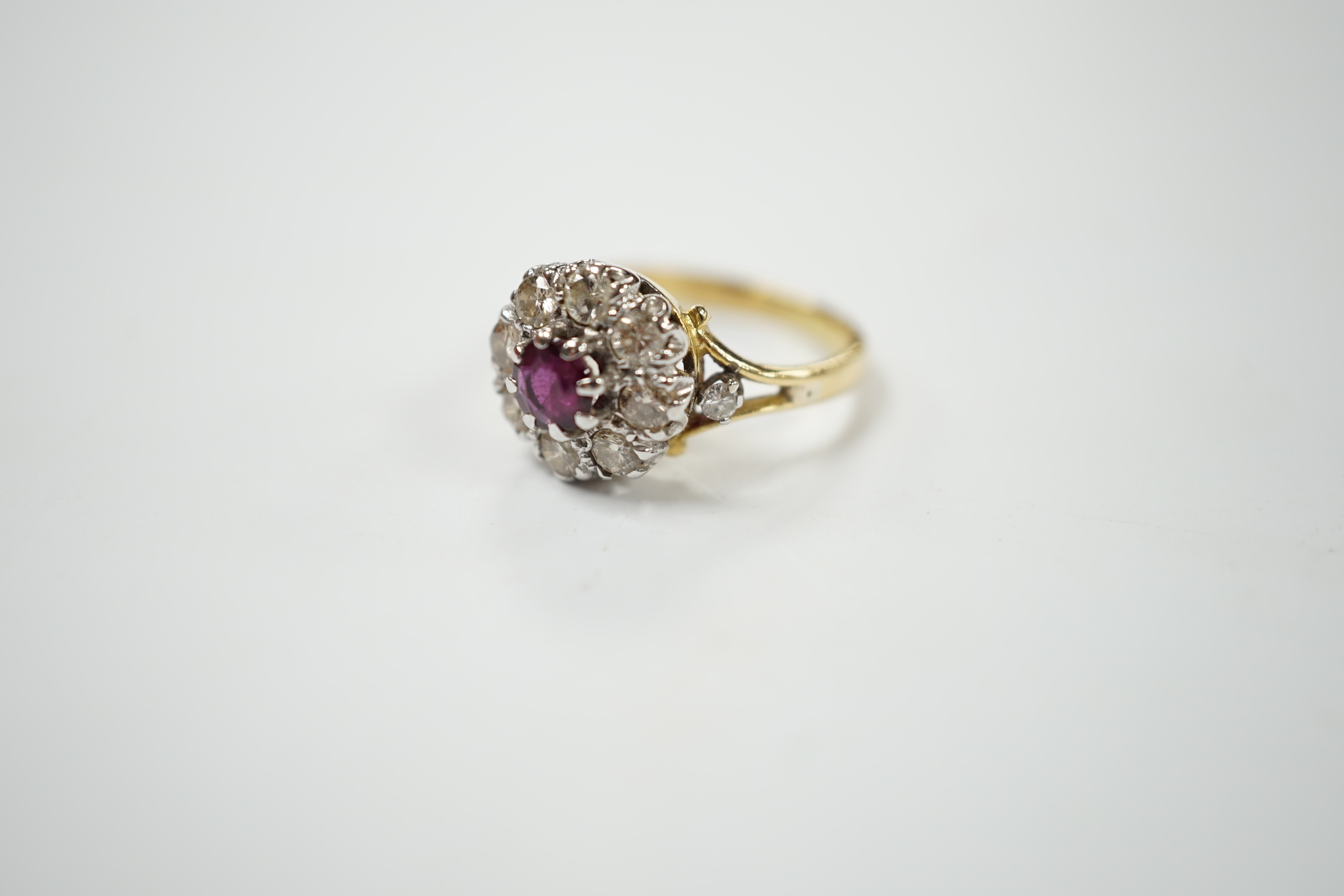 A yellow metal ruby and diamond cluster set flower head ring, size I/J, gross weight 3.6 grams. Condition - fair